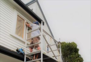 Window fitter retrofitting timber window frames with double glazed units